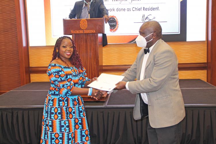 An orhopaedic resident being awarded during Prof. Mulimba's farewell dinner.