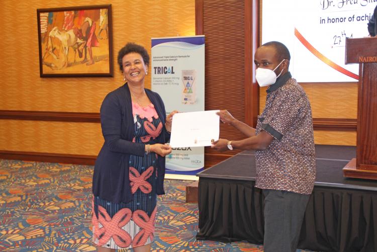 were Prof. Eveline Wagaiyu awards a certificate to Dr. Fred Sitati.